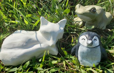 clay animals in the grass