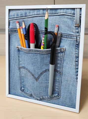 framed denim pocket with pencils and pens
