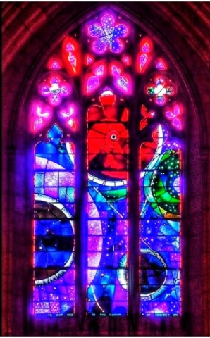 a stained glass window with the moon and sun and stars
