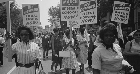 Black and white photo of women protestors with signs