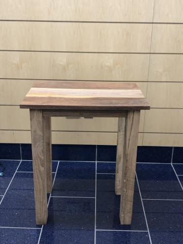 wood table on blue tile and horizontal wood wall