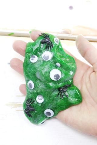 Green sparkly slime with eyeballs. 