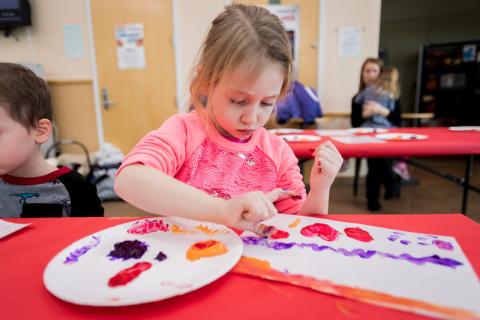 Young girl finger painting