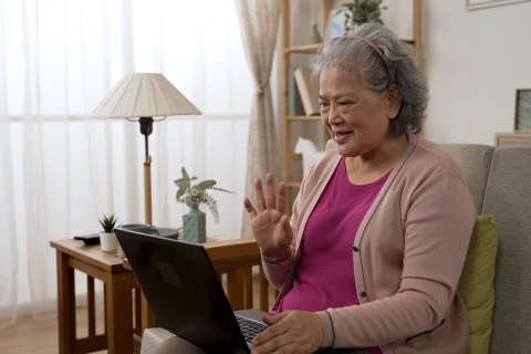 woman sitting on couch using laptop