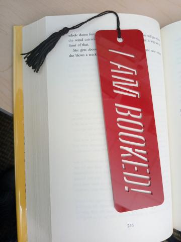 Red Acrylic Bookmark with the text "I am Booked" cut out