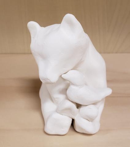 clay figurine of bear holding a bird