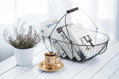 basket of books with a cup of tea