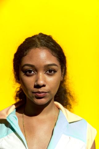 photo of safia in front of a yellow wall 