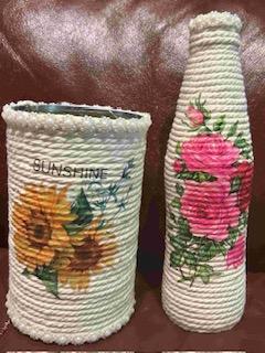 a vase and container decorated with rope and decoupage flowers in pinks and yellows