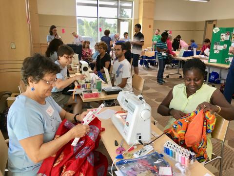 Folks repairing items and mending clothing at Miller Library.