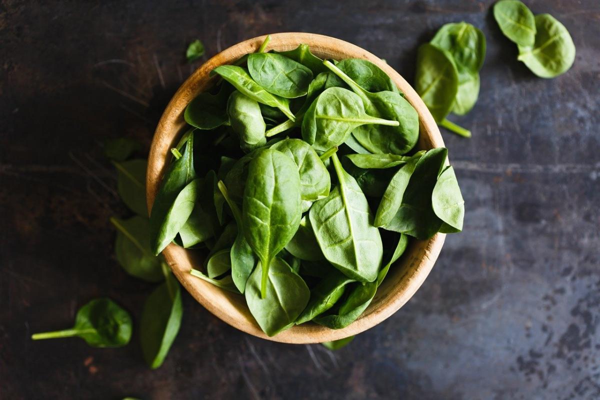 bowl of spinach on a slate countertop