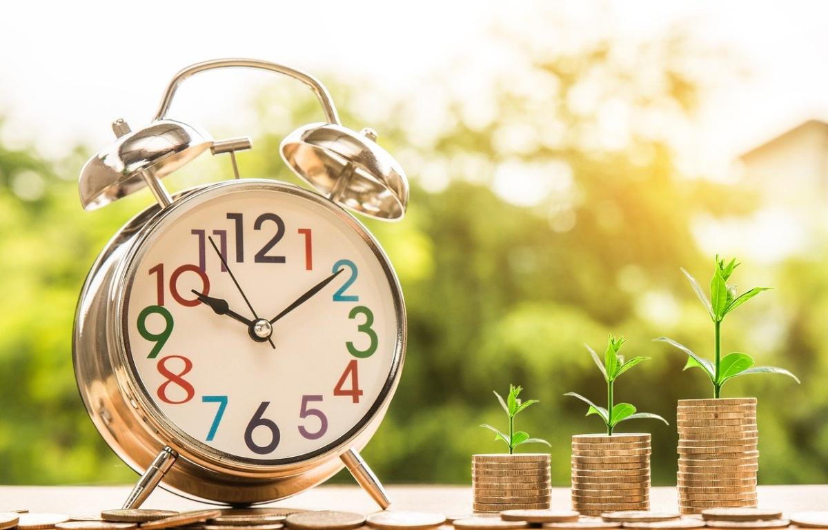 picture of a clock next to a series of coin stacks