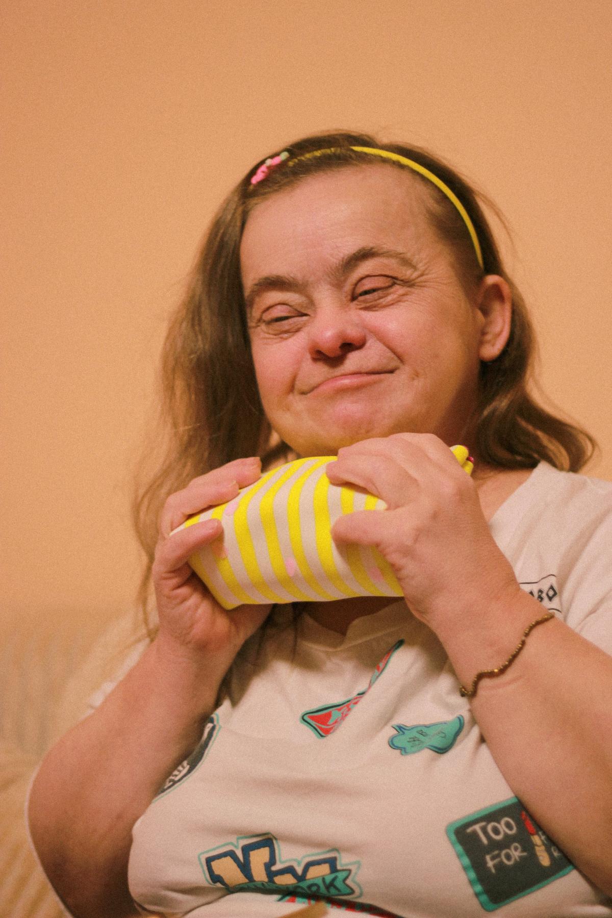 Adult woman with intellectual disability holding a present