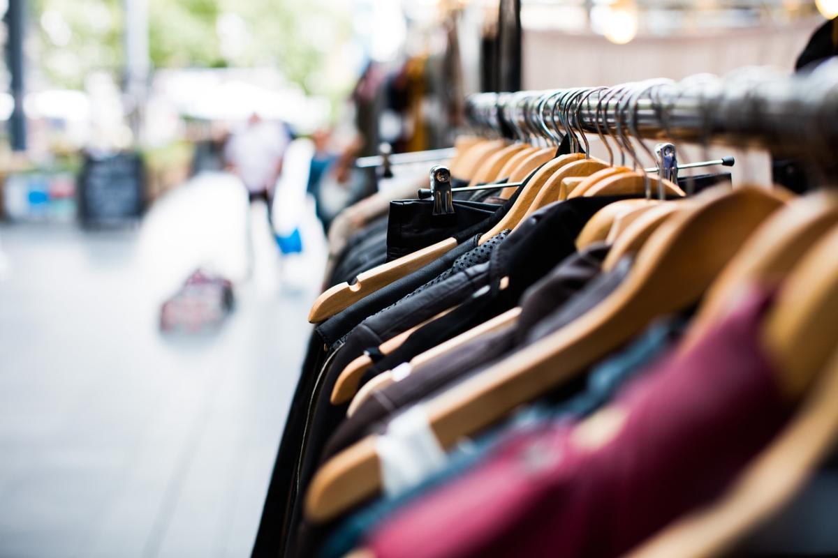 photograph of clothing hanging on metal rack