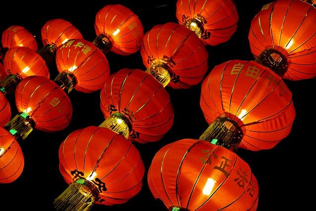 red paper lanterns lit up against a dark sky