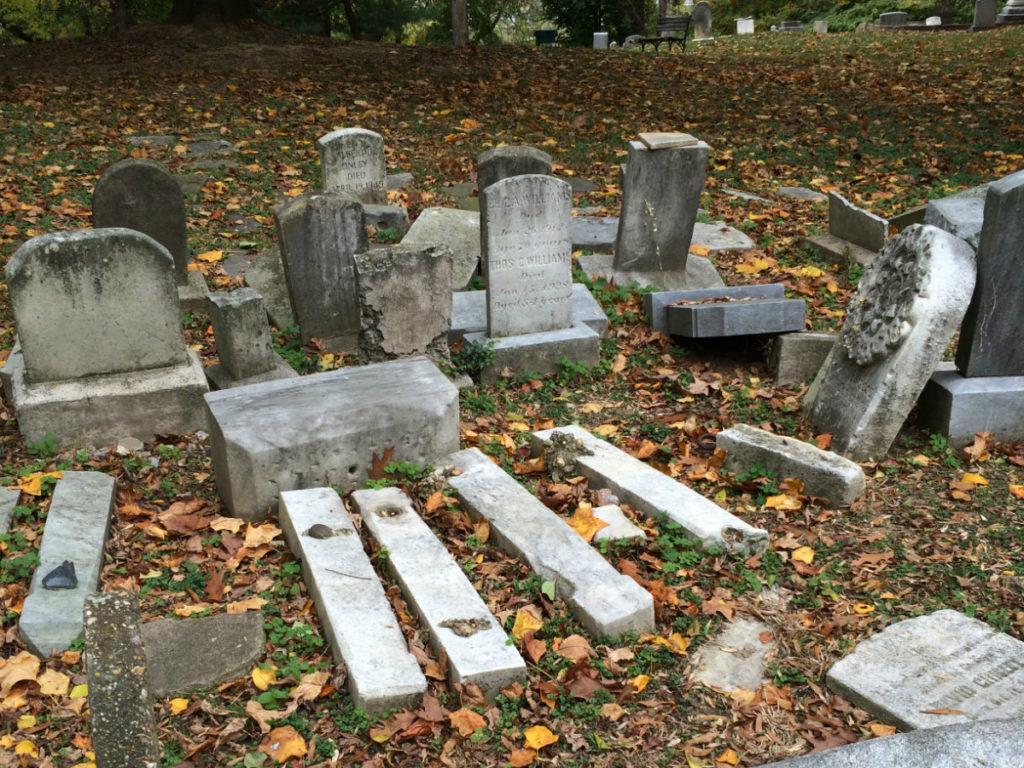 Over fifteen gravestones clustered together, with some knocked over.