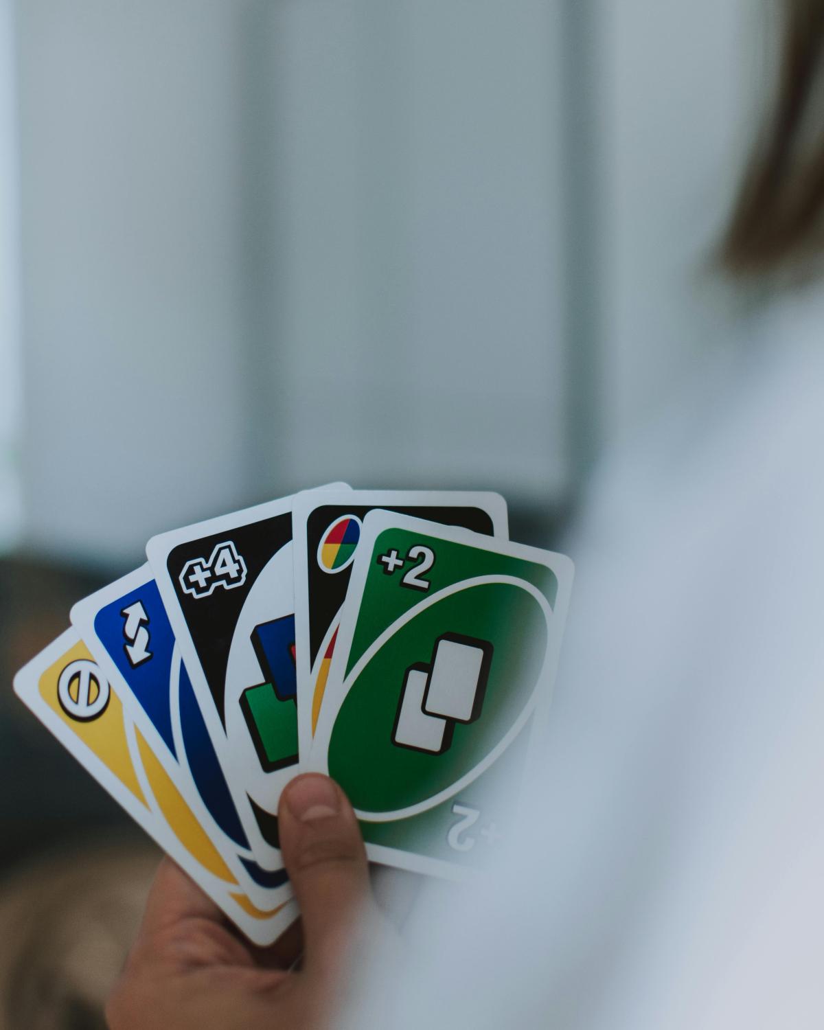 Person with a hand of Uno cards - Pexels Creative Commons