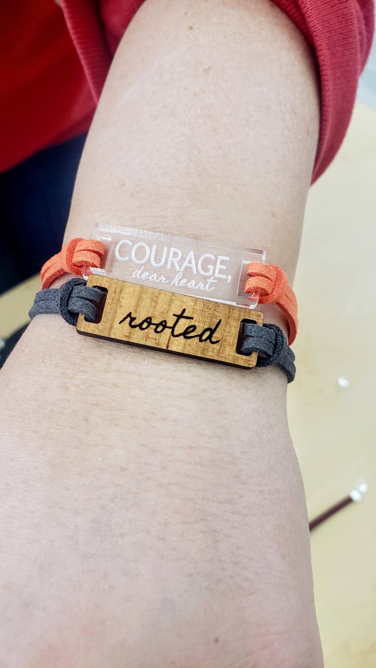 Bracelet engraved with the words "Courage, dear heart" and "rooted"