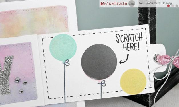 homemade scratch off card on white cardstock with art of 3 balloons, the middle balloon is covered with a scratchable coating; text in the top right corner of the card reads "Scratch here"