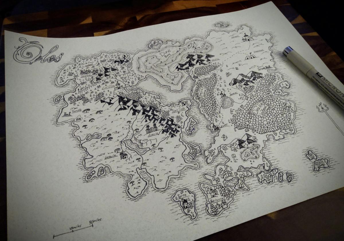 A hand drawn map written in black and white with a black Micron pen laying on top