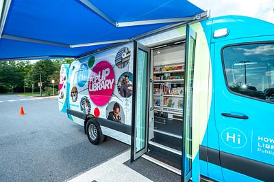 Doors open on the Mobile Library Van showing steps and some items