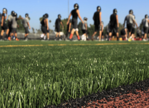 Youth playing on a synthetic turf field.