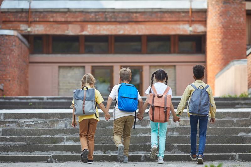 students walking to school building